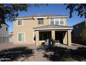 A covered patio overlooks the gravel backyard with easy access to indoor comfort and outdoor relaxation at 26022 N Sandstone Way, Surprise, AZ 85387
