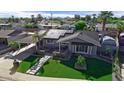 Inviting home with modern landscaping, artificial turf, and solar panels for energy savings at 2656 N 84Th Pl, Scottsdale, AZ 85257