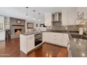 Bright kitchen featuring sleek white cabinetry, modern appliances, and hardwood floors at 2656 N 84Th Pl, Scottsdale, AZ 85257