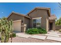 Charming single-story home featuring a two-car garage, secure door, and desert landscaping at 3349 E Merlot St, Gilbert, AZ 85298