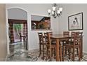 Inviting dining room with a modern chandelier and an open view to the kitchen at 3510 E Hampton Ave # 74, Mesa, AZ 85204