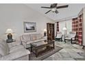 Comfortable living room featuring vaulted ceiling, stone floors, and large window at 3510 E Hampton Ave # 74, Mesa, AZ 85204