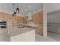 Gourmet kitchen with marble island, sleek cabinetry, pendant lighting, and stainless steel appliances at 39302 N 30Th Dr, Phoenix, AZ 85086