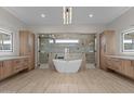 Luxurious bathroom featuring soaking tub, dual vanities, and frameless glass shower at 39302 N 30Th Dr, Phoenix, AZ 85086