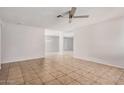 Spacious living room with tile floors, ceiling fan and plenty of natural light at 4611 N 79Th Dr, Phoenix, AZ 85033