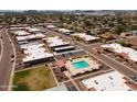Community aerial view showcasing numerous homes and refreshing community pool at 501 W Tonopah Dr # 7, Phoenix, AZ 85027