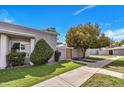 Inviting home exterior featuring lush greenery, a private entrance, and well-maintained landscaping at 5025 W New World Dr, Glendale, AZ 85302