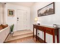The entryway features light tile steps, a hall table, artwork, and a front door with sidelights at 5031 W Grandview Rd, Glendale, AZ 85306