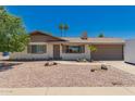 Charming single-story home boasts a well-maintained yard with desert landscaping and an attached two car garage at 5031 W Grandview Rd, Glendale, AZ 85306