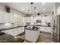 Bright and spacious kitchen with white cabinets, granite countertops, and stainless steel appliances at 6235 S Odessa Dr, Gilbert, AZ 85298