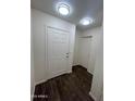 A bright entryway with dark floors and white walls at 6339 W Sophie Ln, Laveen, AZ 85339