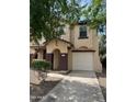 Inviting two-story home featuring a well-manicured lawn and a private two-car garage at 6339 W Sophie Ln, Laveen, AZ 85339