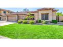 Well-kept lawn with green grass and desert landscaping at 6808 W Angela Dr, Glendale, AZ 85308