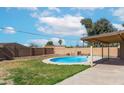 Backyard features a sparkling pool, block fence, and covered patio perfect for outdoor enjoyment at 726 N 78Th St, Scottsdale, AZ 85257