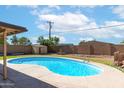 Backyard boasts refreshing pool, shed, and mature trees; perfect for relaxing and entertaining outdoors at 726 N 78Th St, Scottsdale, AZ 85257