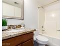 Bathroom featuring a granite countertop, wood vanity, and a shower/tub combo at 815 W El Prado Rd, Chandler, AZ 85225