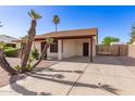 Single story home with desert landscaping, mature palm trees, and covered parking space at 815 W El Prado Rd, Chandler, AZ 85225
