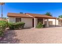 Inviting single-story home featuring a well-kept front yard with desert landscaping and a covered front entry at 815 W El Prado Rd, Chandler, AZ 85225