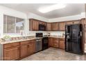 Well-equipped kitchen features granite countertops, wood cabinets, stainless steel appliances, and ample counter space at 815 W El Prado Rd, Chandler, AZ 85225