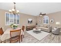 Bright dining room featuring a chandelier, large windows, and stylish decor at 8210 W Wethersfield Rd, Peoria, AZ 85381