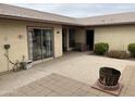 Spacious patio area featuring a built-in fire pit and easy access through a sliding glass door at 973 Leisure World --, Mesa, AZ 85206