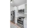 Modern kitchen with stainless steel appliances and white cabinetry at 9820 N Central Ave # 303, Phoenix, AZ 85020