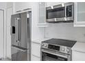 Modern kitchen with stainless steel appliances and white cabinetry at 9820 N Central Ave # 303, Phoenix, AZ 85020