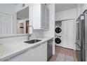 Functional kitchenette featuring a dishwasher and stackable washer/dryer units at 9820 N Central Ave # 303, Phoenix, AZ 85020