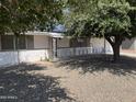 Inviting front yard with desert landscaping and mature shade tree enhancing curb appeal at 10728 W El Rancho Dr, Sun City, AZ 85351