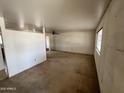 Spacious living room featuring an open layout, ceiling fan, and abundant natural light at 10728 W El Rancho Dr, Sun City, AZ 85351