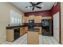 Well-equipped kitchen with black appliances, granite countertops, and ample cabinet space for storage at 1391 W Windhaven Ave, Gilbert, AZ 85233