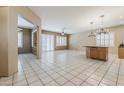 Open living room with neutral paint, tile floors, and ample natural light streaming through plantation shutters at 1391 W Windhaven Ave, Gilbert, AZ 85233