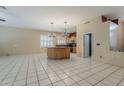 Spacious living area featuring tile floors, plantation shutters, and access to the kitchen for easy entertaining at 1391 W Windhaven Ave, Gilbert, AZ 85233