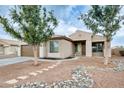 Inviting single-story home with desert landscaping and charming stone walkway at 14752 W Evans Dr, Surprise, AZ 85379
