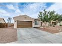 Single-story home featuring a two-car garage with brown gravel landscaping at 14752 W Evans Dr, Surprise, AZ 85379