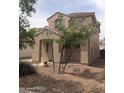 Two-story home with desert landscaping and a front porch at 15446 W Jenan Dr, Surprise, AZ 85379