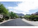 Picturesque street view with lush landscaping and mountain views in a tranquil neighborhood at 15806 N 107Th Pl, Scottsdale, AZ 85255