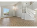 Bright, open living room with wood-style tile flooring and a staircase leading to the second floor at 1741 S Clearview Ave # 74, Mesa, AZ 85209