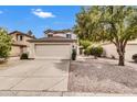 Inviting home with a two-car garage, desert landscaping, mature trees, and a well-manicured front yard at 1811 S 39Th St # 30, Mesa, AZ 85206