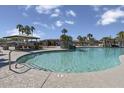 Community pool with plenty of space for lounging and swimming, plus palm trees adding a resort-like feel at 18540 N Foxtail Dr, Maricopa, AZ 85138