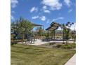 Outdoor recreation area with shaded seating, picnic tables, and a ' playground for community enjoyment at 21151 E Arrowhead Trl, Queen Creek, AZ 85142