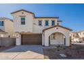 Beautiful two-story house boasts a brown two-car garage, a welcoming arched entrance, and a clean, modern design at 2195 N Peden Dr, Chandler, AZ 85225