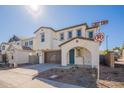 Inviting two-story residence featuring a brown garage, arched entryway, manicured landscaping, and a pristine white facade at 2195 N Peden Dr, Chandler, AZ 85225