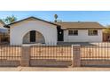 Inviting single-story home featuring a secure fence and unique archway entryway at 2242 W Pecan Rd, Phoenix, AZ 85041