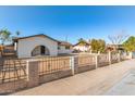 Exterior view of home showcasing its secure fencing and low maintenance yard at 2242 W Pecan Rd, Phoenix, AZ 85041