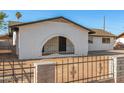 Close-up of house exterior featuring unique archway entryway and secure fencing at 2242 W Pecan Rd, Phoenix, AZ 85041