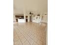 Spacious living room with tile floors, neutral paint, open staircase, and convenient access to the kitchen at 22872 W Gardenia Dr, Buckeye, AZ 85326