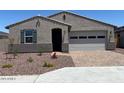 Charming single story home featuring a low maintenance rock yard, attached two car garage, and covered entryway at 24486 W Grenadine Rd, Buckeye, AZ 85326