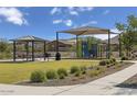 Community playground featuring modern play equipment and a covered picnic area at 2735 W La Mirada Dr, Laveen, AZ 85339