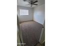 Cozy bedroom featuring fresh carpeting, a ceiling fan, and a bright window at 2908 N 53Rd Ln, Phoenix, AZ 85031